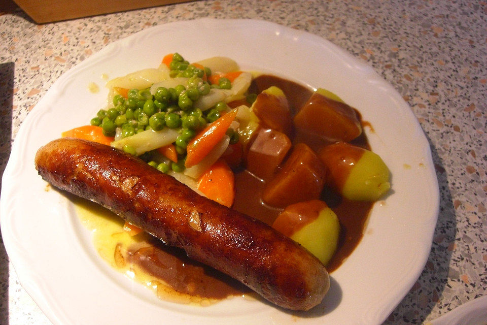 Frische Bratwurst in einer Apfel-Malzbier-Sauce mit Kartoffeln und Rotkohl