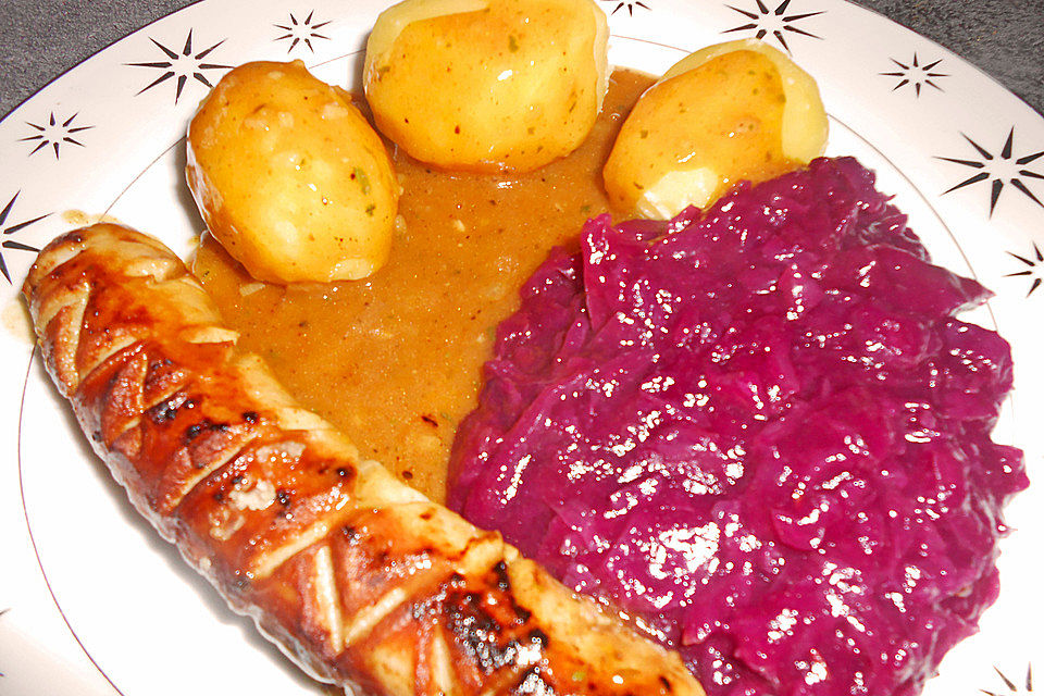 Frische Bratwurst in einer Apfel-Malzbier-Sauce mit Kartoffeln und Rotkohl