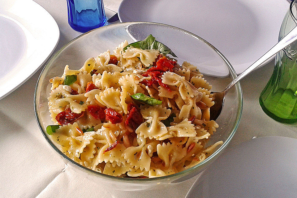 Nudelsalat mit getrockneten Tomaten, Pinienkernen, Schafskäse und Basilikum