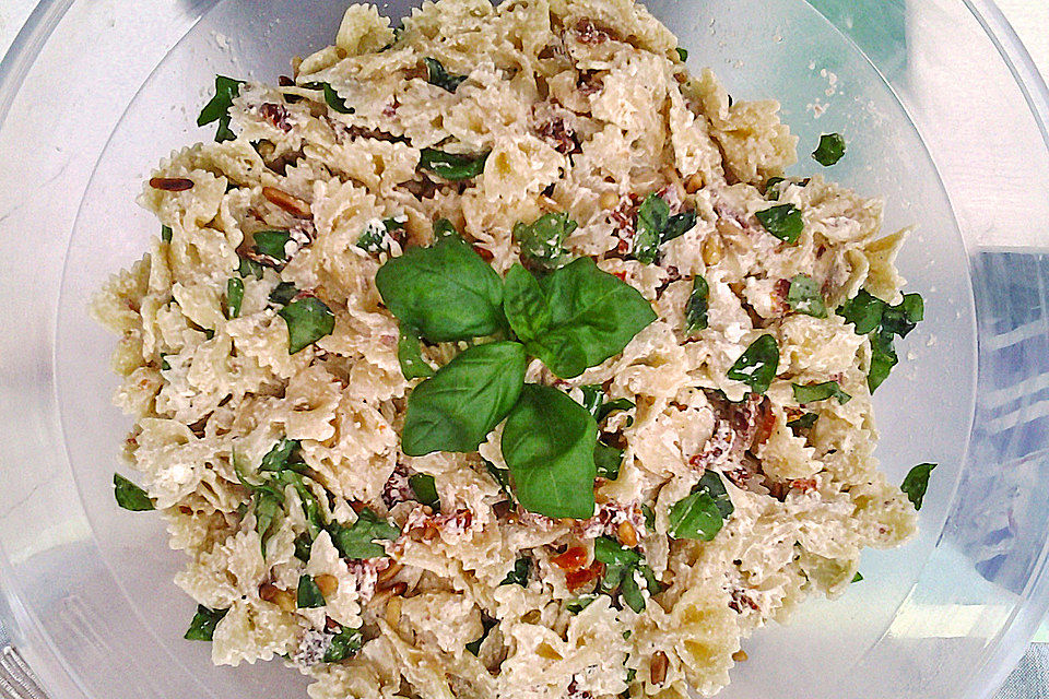 Nudelsalat mit getrockneten Tomaten, Pinienkernen, Schafskäse und Basilikum