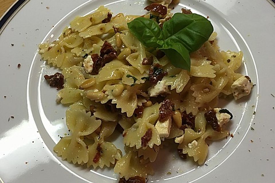 Nudelsalat mit getrockneten Tomaten, Pinienkernen, Schafskäse und Basilikum