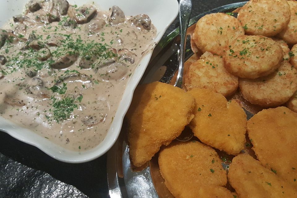 Champignons in Weißweinsauce auf Rösti