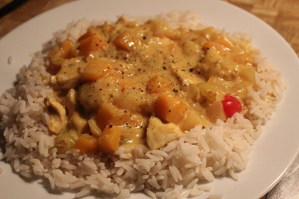 Curryhuhn mit Reis und tropischen Früchten