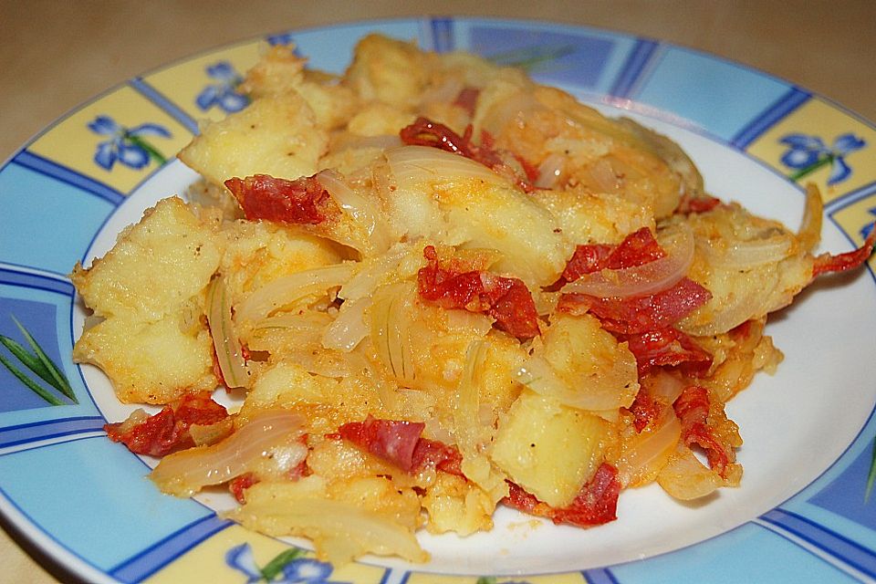 Patatas con chorizo en salsa de naranje