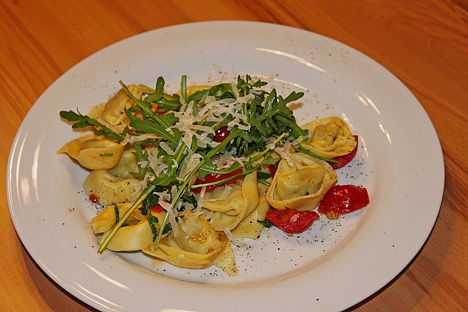 Ricotta-Tortellini mit Rucola, Tomaten und Pinienkernen