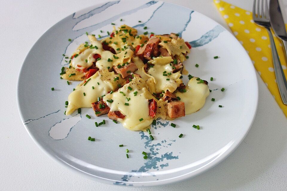 Penne-Schmandpfanne mit Leberkäs, Schnittlauch, Paprika und Käse