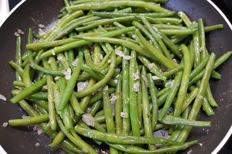 Grüne Bohnen mit Zwiebeln in Butter geschwenkt