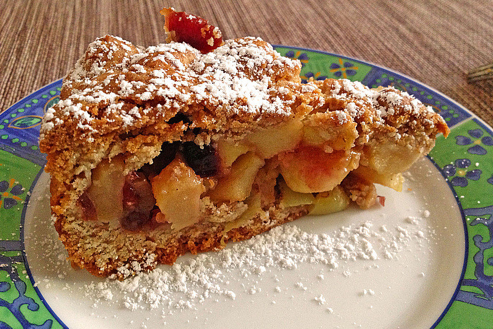 Gedeckter Apfelkuchen mit Weintrauben und Cranberries