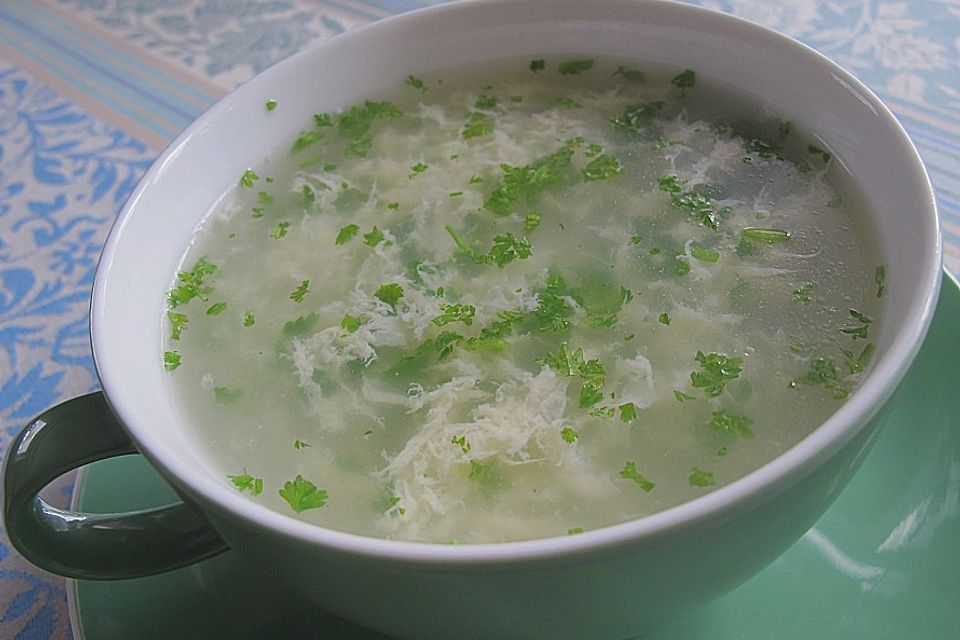 Klare Spargelsuppe mit Eierblumen und frischen Kräutern