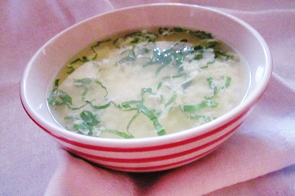 Klare Spargelsuppe mit Eierblumen und frischen Kräutern