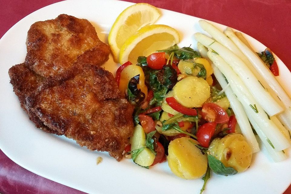 Panierte Feta-Schnitzel auf buntem Salat