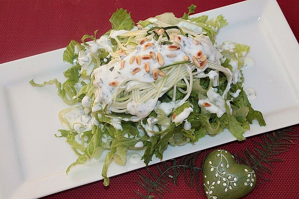 Blattsalat mit Zucchinijulienne, Pinienkernen und italienischem Joghurtdressing