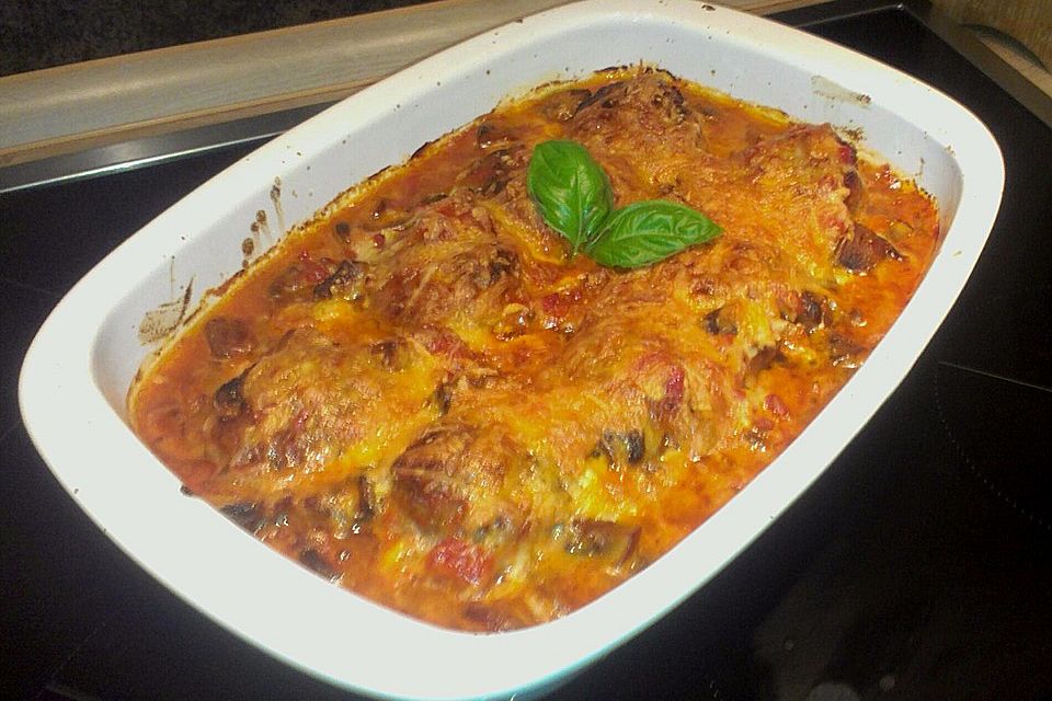 Überbackene Buletten mit Champignons in Tomatensauce