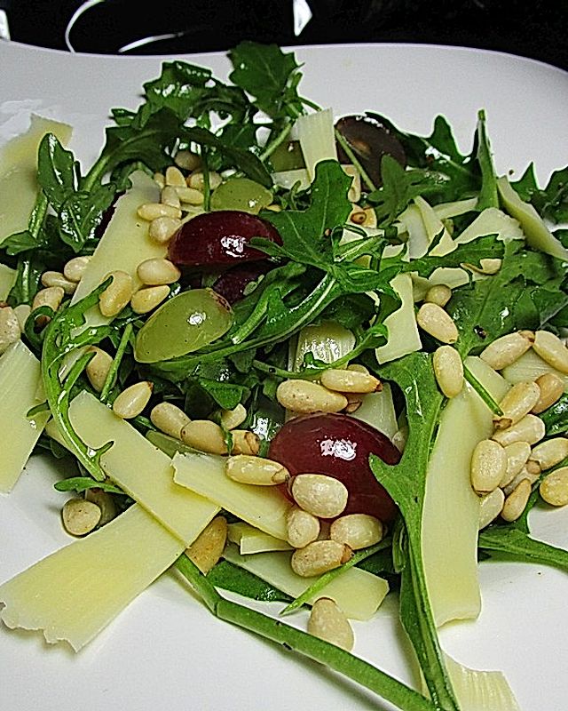 Rucola-Trauben-Salat mit Käsestreifen und gerösteten Pinienkernen