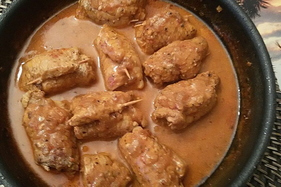 Feurige Schweineröllchen in Tomaten-Zwiebel-Soße