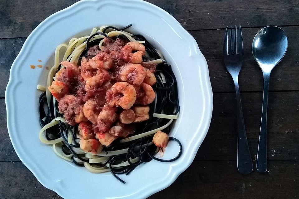 Spaghetti mit Garnelen, Surimi und Tomaten in Knoblauchöl