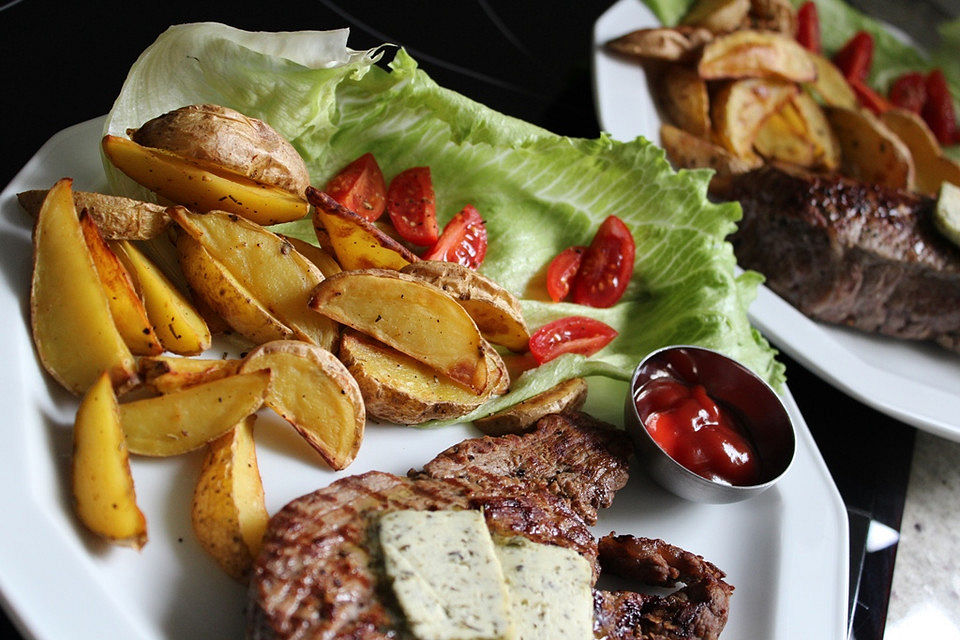 Kartoffelspalten mit Tomatenketchup und Salat