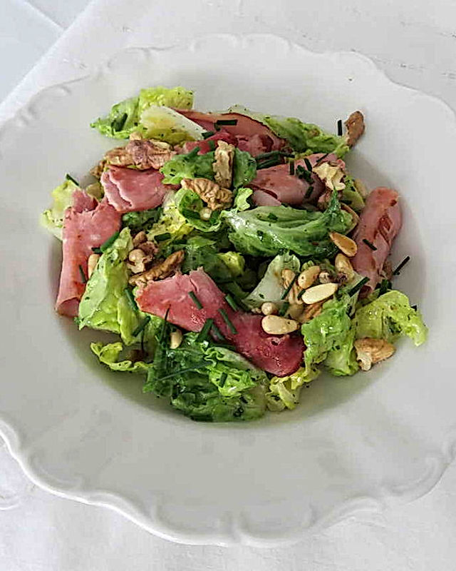 Grüner Salat mit gebratenen Schinkenröllchen, Walnüssen und Pinienkernen