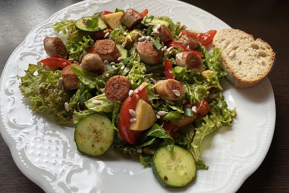 Salat mit Tomaten, Gurke und Bratwurst