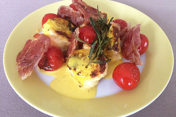 Ricotta-Nocken mit Zitronen-Safran-Sauce, karamellisiertem Prosciutto und gebratenen Tomaten