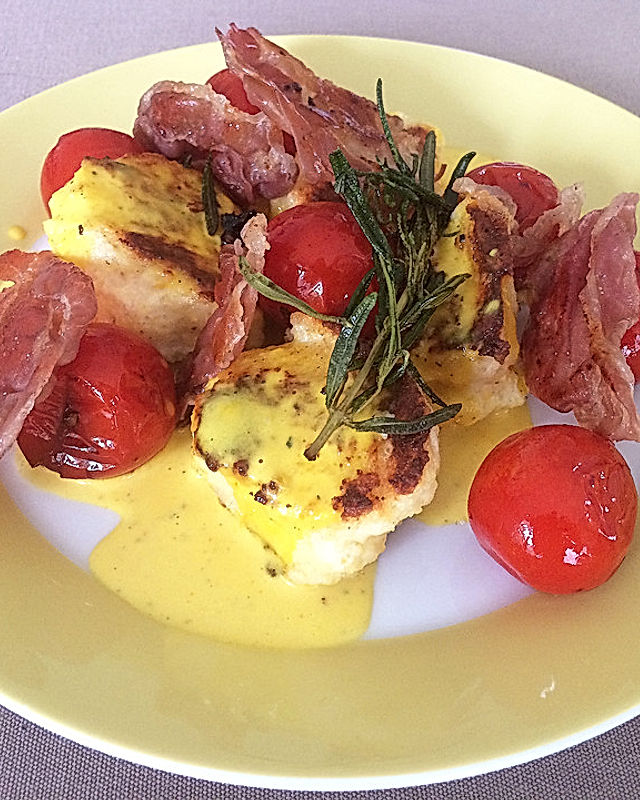Ricotta-Nocken mit Zitronen-Safran-Sauce, karamellisiertem Prosciutto und gebratenen Tomaten