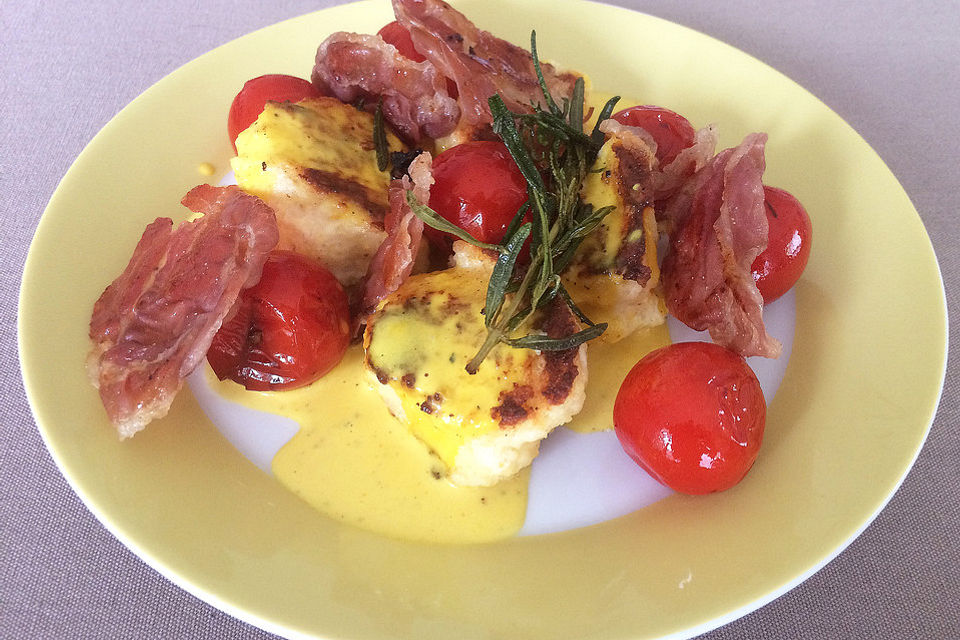 Ricotta-Nocken mit Zitronen-Safran-Sauce, karamellisiertem Prosciutto und gebratenen Tomaten