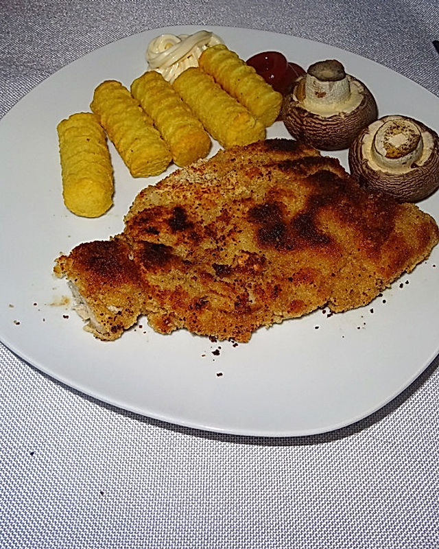 Schnitzel aus Kotelettfleisch mit Kroketten und Riesenchampignons à la Didi