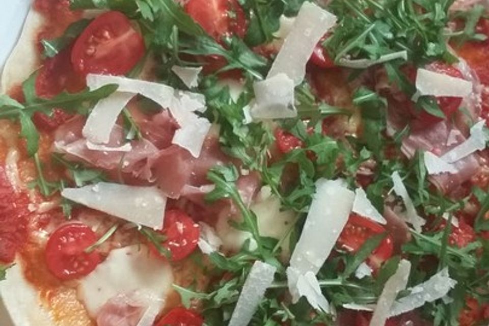 Pizza mit Rucola und Parmaschinken