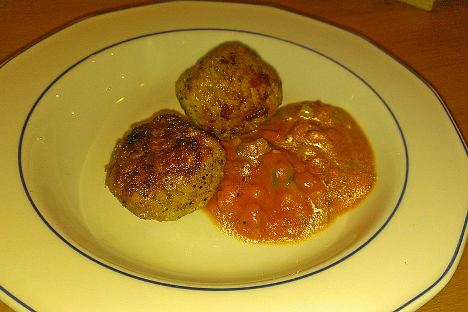 Reisbällchen auf Tomatengemüse